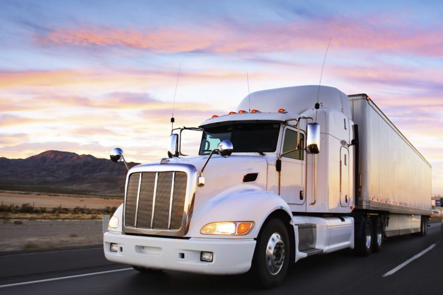 Truck and highway at sunset - transportation background